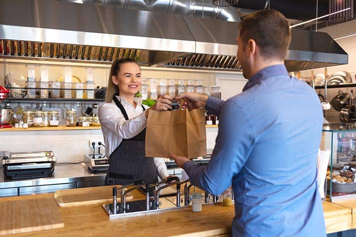 Customer picking up restaurant takeout order